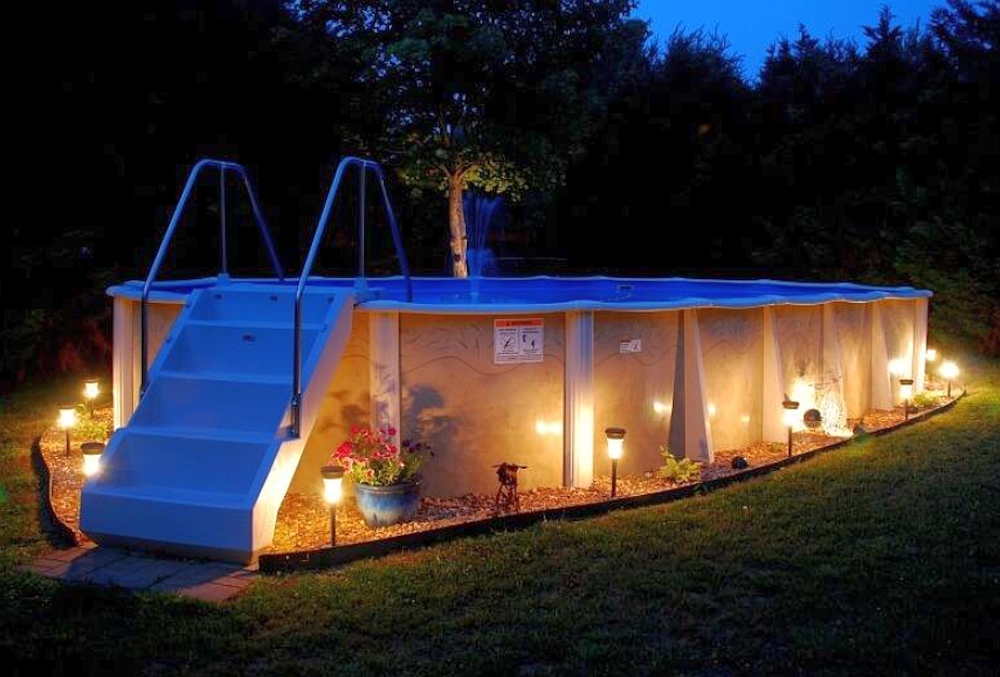 Above ground pool at night with lights